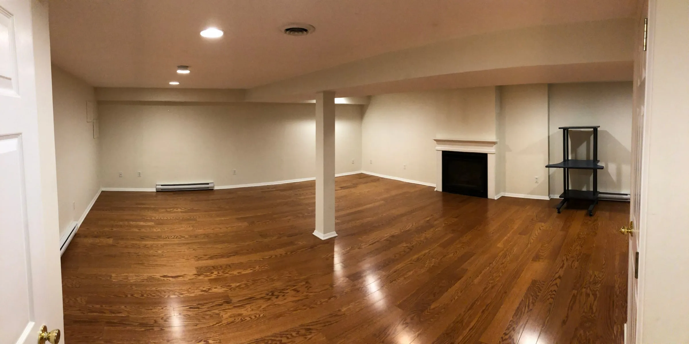 Finished basement family room with recessed lighting