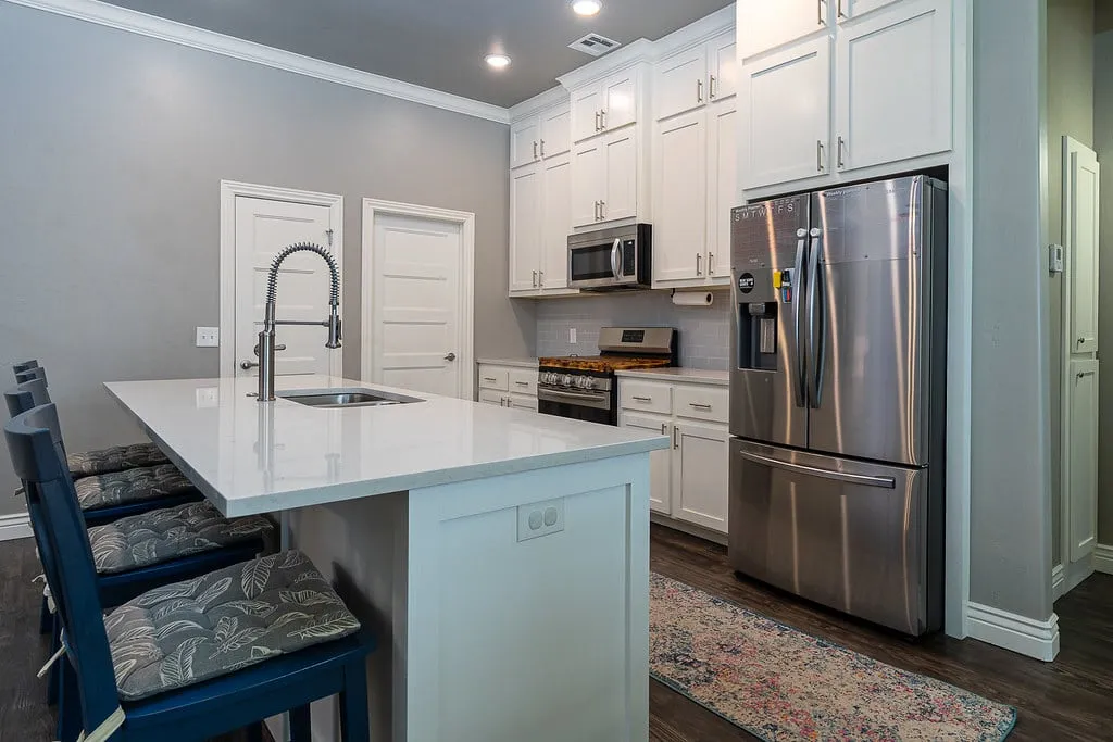 Bright kitchen with white cabinets and a stone island