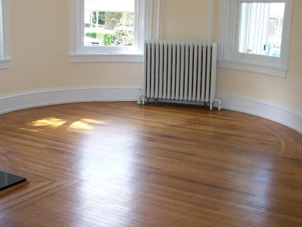 Empty living room with new wood floors and freshly painted walls